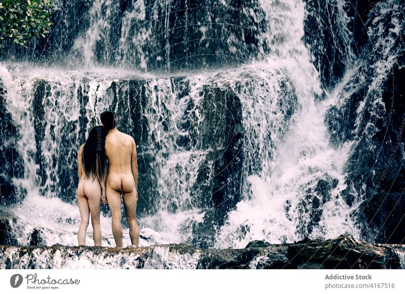 Unerkanntes nacktes Paar am Wasserfall Natur genießen Landschaft Windstille schließen Partnerschaft Sommer Zusammensein Körper Felsen romantisch Liebe sinnlich