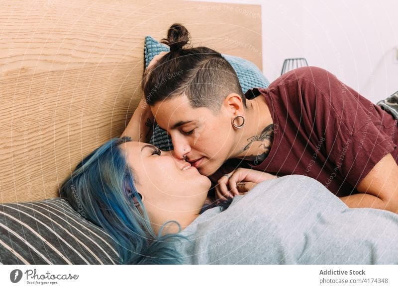 Junges lesbisches Paar küsst sich auf dem Bett Frauen Kuss Liebe Glück Angebot Partnerschaft Freundin Schlafzimmer heimwärts androgyn Bonden Zusammensein