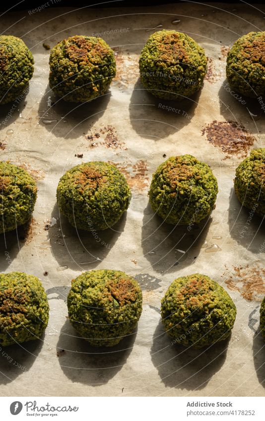 Grüne vegane Falafelbällchen auf Backpapier grün gebacken Edamame Bohne Erbse Veganer Vegetarier Lebensmittel Tradition mediterran arabisch Naher Osten Knusprig