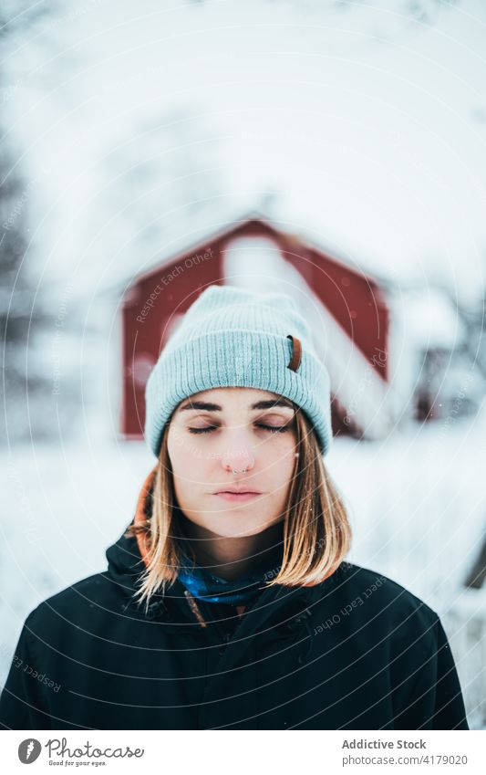 Ruhige Frau in warmer Kleidung genießt den Winter genießen ruhig Natur warme Kleidung Winterzeit kalt Schnee weiß Oberbekleidung Dorf Gelassenheit