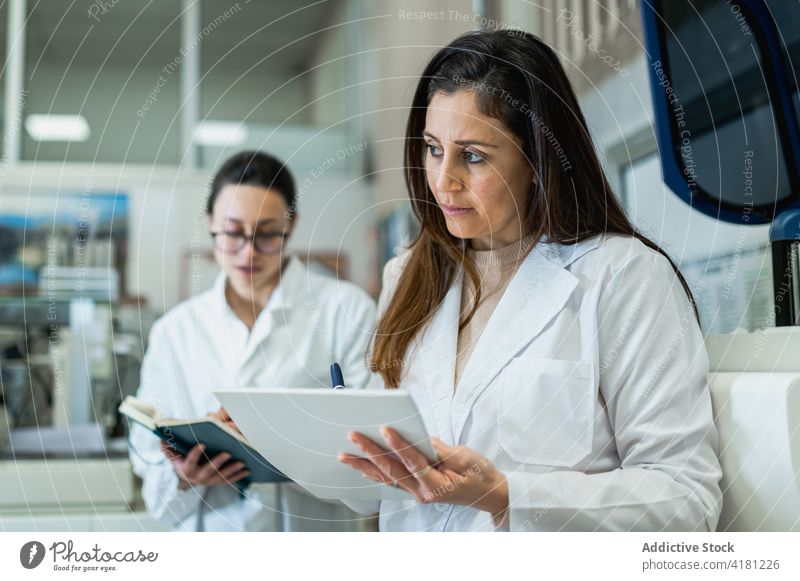 Fröhliche Wissenschaftler im Gespräch im Labor Kollege Frauen medizinisch Arbeit Zusammensein wissenschaftlich Mitarbeiterin unter professionell Gerät Apparatur