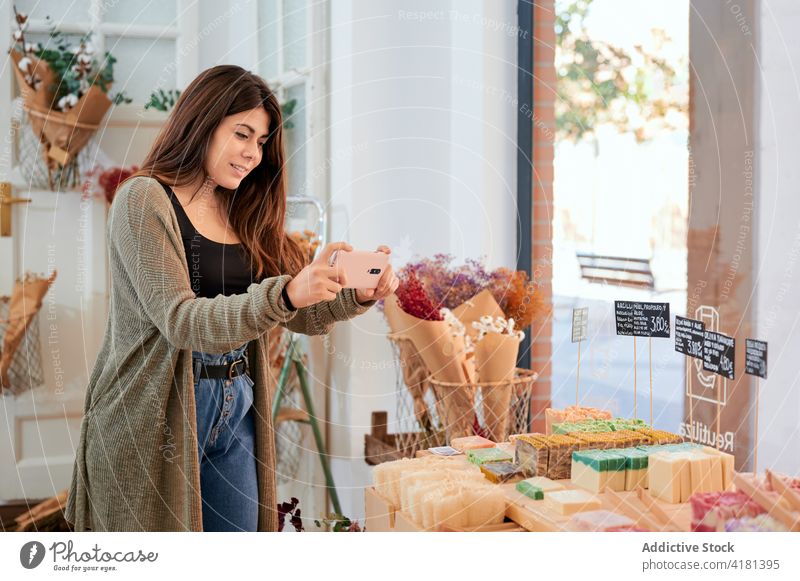 Positive Frau fotografiert handgemachte Seife Käufer handgefertigt organisch fotografieren Smartphone Preis Wahl Laden keine Verschwendung Werkstatt Produkt