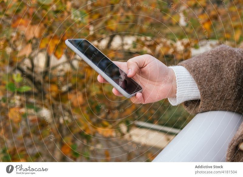 Anonyme Frau beobachtet Smartphone in der Stadt zuschauend Internet online Freizeit Wochenende benutzend Apparatur freie Zeit Großstadt Gerät heiter