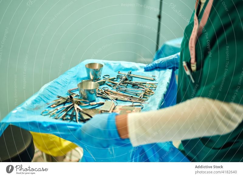 Unbekannte Krankenschwester nimmt verschiedene Instrumente während einer Operation im Operationssaal wählen Krankenhaus Krankenpfleger Chirurgie Arbeit