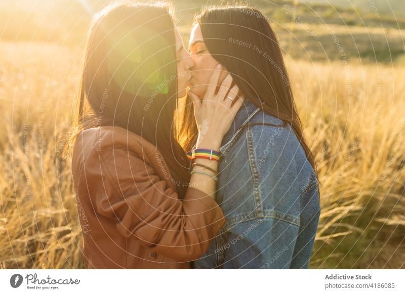 Paar Frauen küssen sich auf einem Feld lesbisch Kuss Angebot Liebe Zusammensein Partnerschaft lgbt lgbtq Homosexualität genießen verliebt Zuneigung Freundin