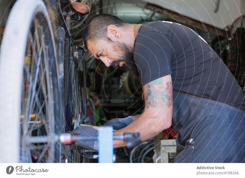 Anonymer Mann repariert Fahrrad in Garage - ein lizenzfreies Stock Foto von  Photocase