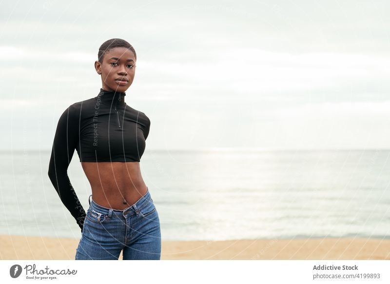 Trendiges schwarzes Modell am Meeresufer Frau Kurze Haare Stil sensibel Bauch sanft Porträt trendy Angebot romantisch feminin herzlich Afroamerikaner Küste