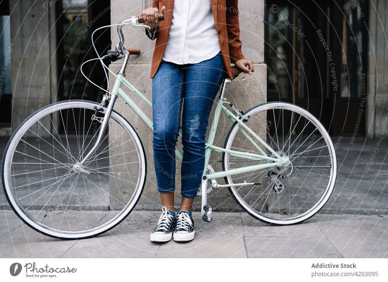 Ethnische Frau steht mit Fahrrad an der Straße Arbeitsweg Großstadt smart lässig Spaziergang trendy Stil schwarz Afroamerikaner ethnisch urban Zeitgenosse