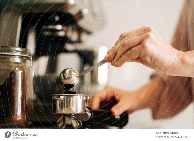 Eine Frau gießt Kaffee in eine Filterkanne Hand Portafilter eingießen vorbereiten Kaffeemaschine Küche Gerät Küchengeräte heimisch heimwärts professionell