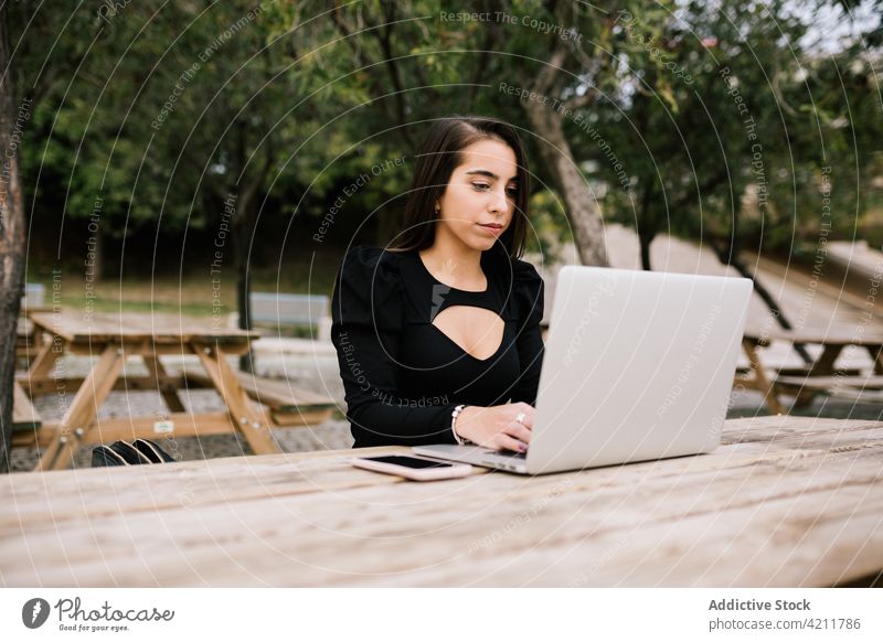 Geschäftsfrau bei der Arbeit im Stadtpark Frau Laptop abgelegen Park Unternehmer Tisch Browsen Fokus Gerät Netbook Business freiberuflich sitzen Beruf Tippen