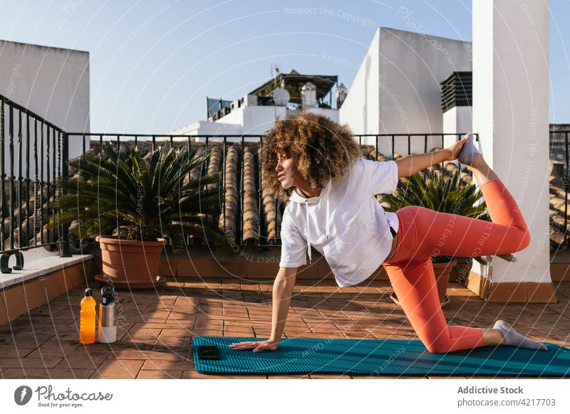 Schwarze Frau macht Yoga-Pose auf dem Dach Dachterrasse üben Training Asana Gleichgewicht sich[Akk] entspannen ethnisch schwarz Afroamerikaner Harmonie