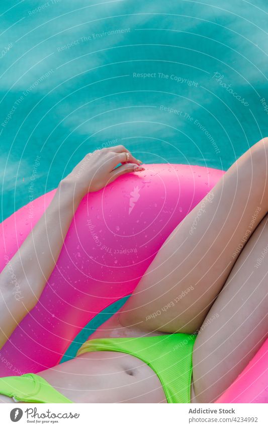 Crop übergewichtige Reisende im Badeanzug mit Gummiring gegen Pool Reisender Badebekleidung Urlaub Körper sinnlich Ausflug Frau Bikini feminin mollig Kurve