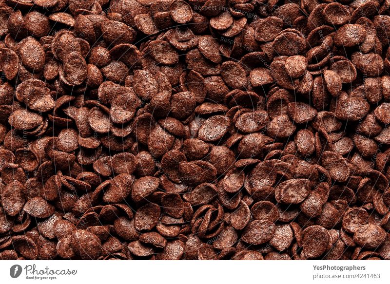 Schokolade Cornflakes Müsli, Hintergrund, Ansicht von oben. Frühstückscerealien Nahaufnahme, Vollbild obere Ansicht Überfluss braun Zerealien Kindheit
