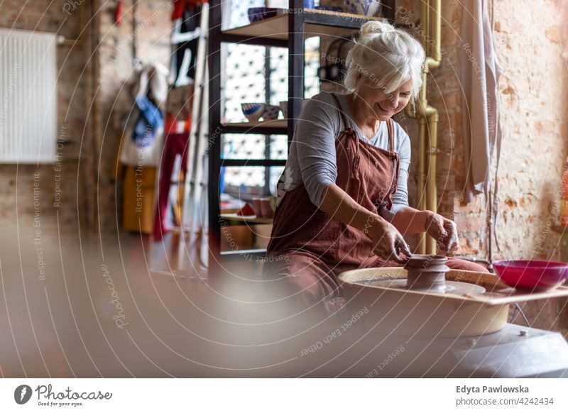 Ältere Frau macht Keramikarbeit mit Töpferscheibe Töpferwaren Künstler Kunst Arbeit arbeiten Menschen Senior Erwachsener lässig attraktiv Glück Kaukasier
