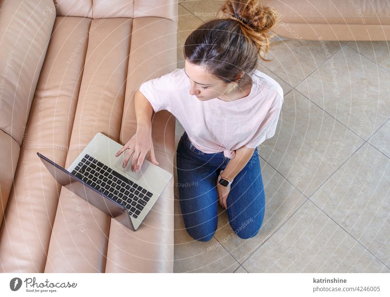 Junge Frauen verwenden einen Laptop, während sie zu Hause auf dem Boden sitzen jung anhaben Attrappe T-Shirt lernen Schüler Lifestyle Jeanshose Brille ernst