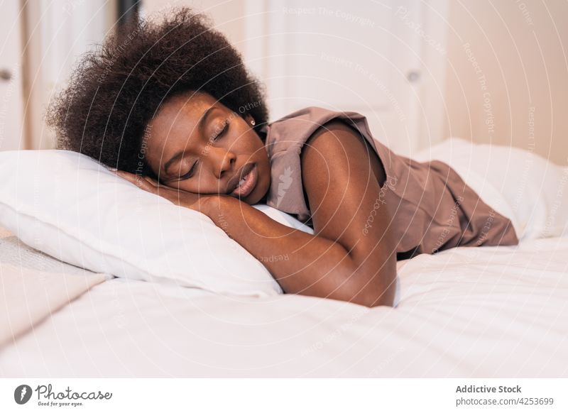 Junge schwarze Frau schläft auf einem bequemen Bett zu Hause schlafen Augen geschlossen sich[Akk] entspannen Lügen Schlafzimmer Kopfkissen schlafend Morgen