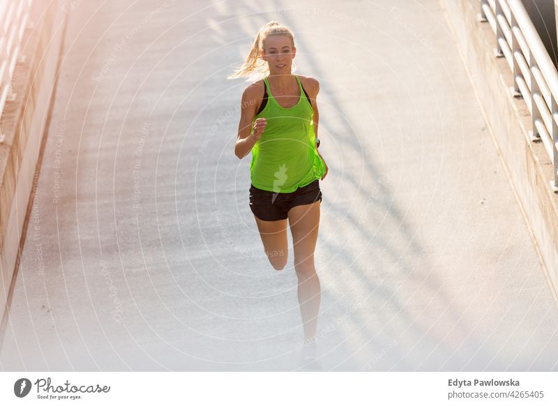 Läuferin in einem städtischen Gebiet Energie trainiert. Fitness Sport Aktivität Vitalität Körper Turnkleidung Training anstrengen beweglich Flexibilität urban