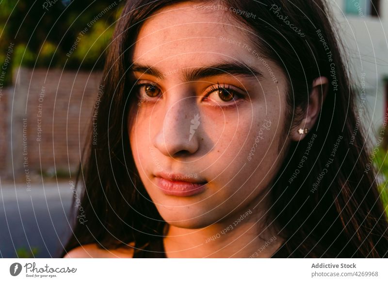Teenager steht auf der Straße im Sonnenlicht besinnlich feminin sanft Angebot tausendjährig Schatten Porträt Profil nachdenklich Zeitgenosse Generation