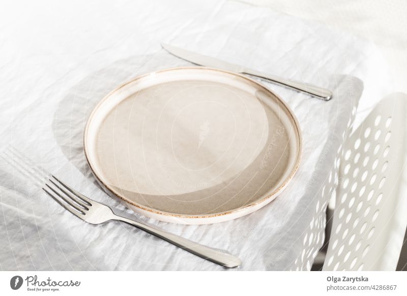 Leerer Teller auf weißem Leinentischtuch. leer Einstellung Tisch Tischwäsche Sonnenlicht niemand Winkelansicht sehr wenige Stuhl Wand Küche