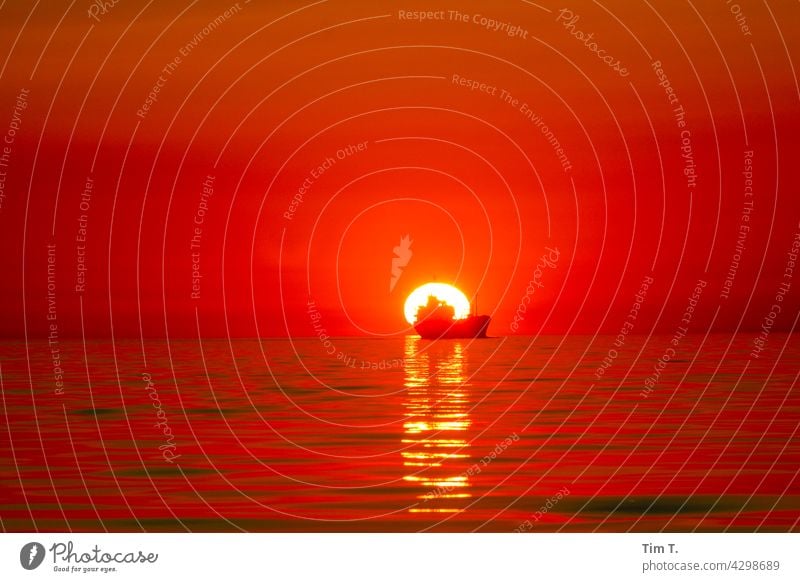 ein Handelsschiff fährt in den Sonnenuntergang handelsschiff frachtschiff Meer See Sonnenlicht Schifffahrt Wasser Wasserfahrzeug Horizont Himmel