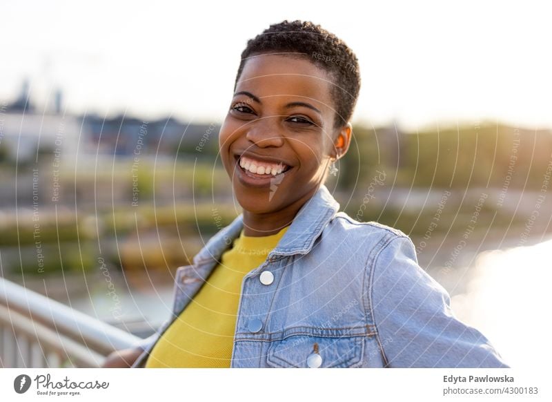 Porträt einer schönen glücklichen Frau im Freien Afro-Look stolz echte Menschen Stadtleben Afroamerikaner Afrikanisch Schüler schwarz Ethnizität sonnig