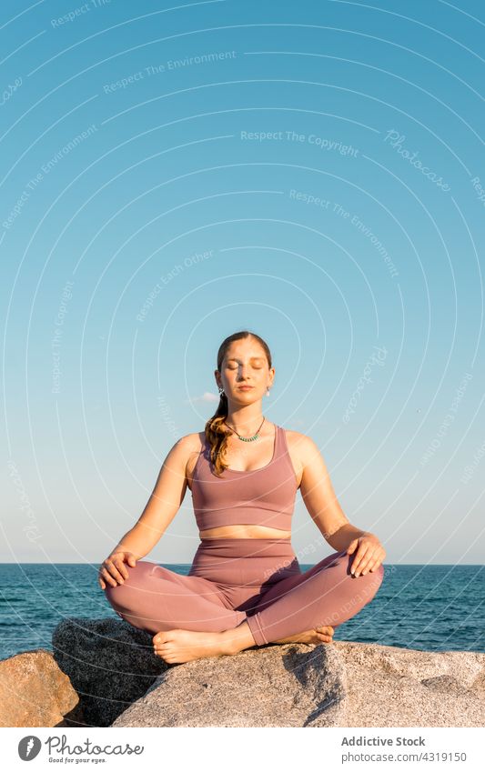 Frau übt Yoga in Lotus-Pose am Strand meditieren Asana Zen üben Achtsamkeit Gesundheit Ufer Gleichgewicht padmasana Windstille sich[Akk] entspannen Wellness