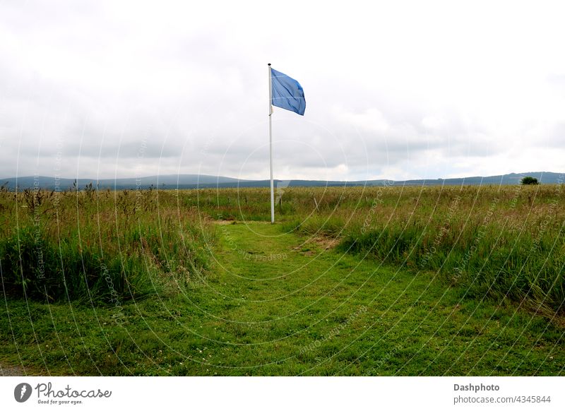 Blaue Gedenkfahne auf dem Culloden Battlefield in Schottland Fahne blau blaue Flagge feierlich zum Gedenken an Jakobiten jacobites weiß Tourismus