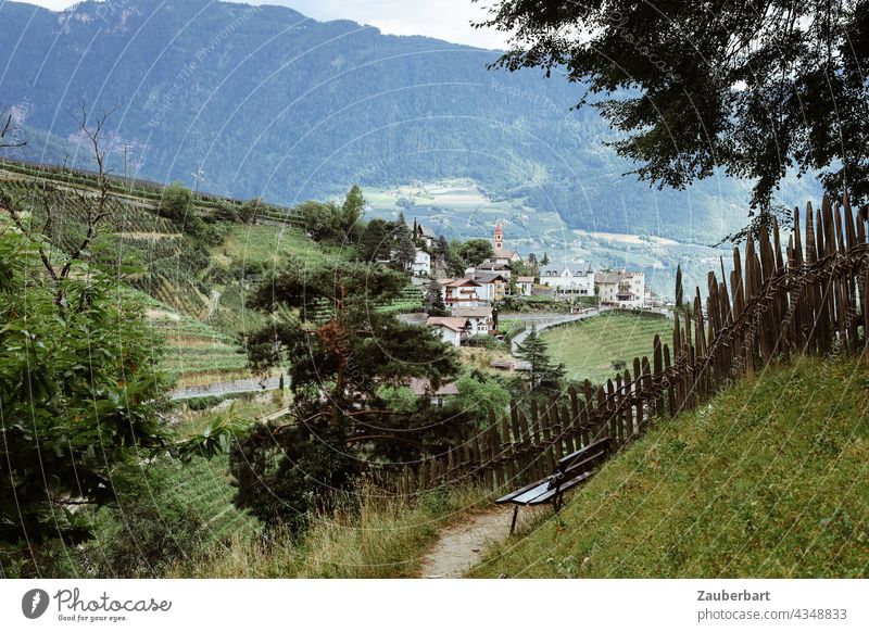 Blick während Wanderung auf ein Dorf, im Vordergrund Bank und Zaun, im Passeier-Tal in Südtirol Idylle Berge Berge u. Gebirge Alpen Sommer Landschaft