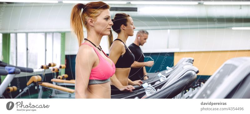 Menschen trainieren auf Laufbändern im Fitnesscenter Panorama Menschengruppe Frau Training Laufband Maschine Textfreiraum Zentrum Joggen Dehnübung Herz rennen