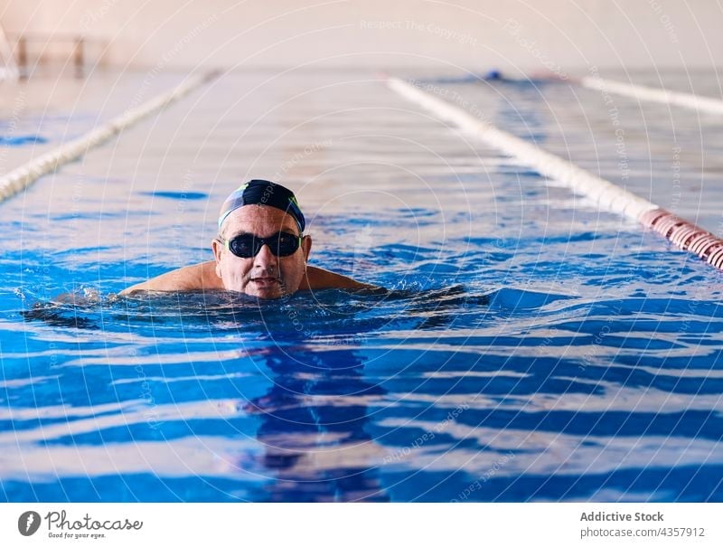 Älterer Mann schwimmt im Pool schwimmen Wasser Aerobic Schwimmer Übung Training Aktivität reif männlich aqua Wohlbefinden Vitalität Wellness Brille