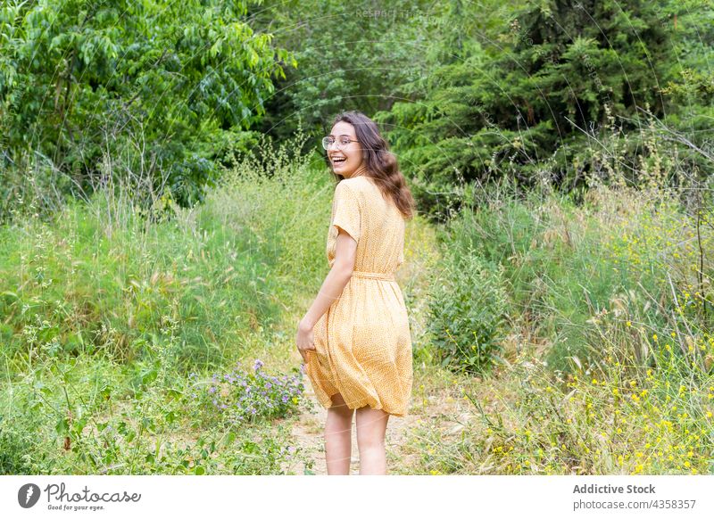 Unbeschwerte Frau beim Spaziergang im Sommerpark Park Kleid Lächeln heiter sorgenfrei genießen schlendern Freude Natur Stil positiv charmant Glück Optimist froh
