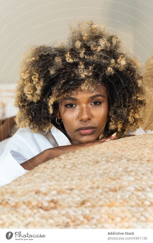 Nachdenkliche schwarze Frau auf dem Bett liegend im Schlafzimmer genießen ruhen positiv Komfort sich[Akk] entspannen Morgen Vergnügen Glück Optimist Freude
