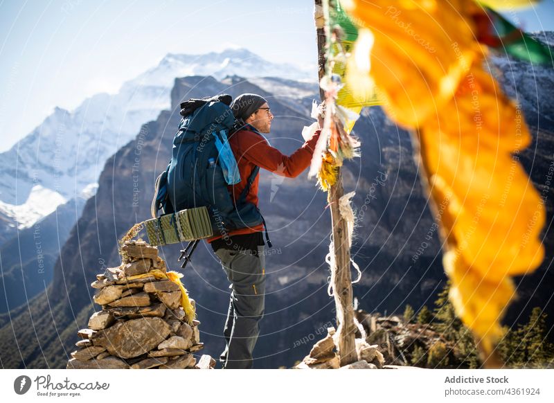 Reisender Mann hängt Gebetsfahne in den Bergen auf Berge u. Gebirge Fahne buddhistisch hängen Abenteuer Hochland reisen männlich Himalaya Nepal Freiheit