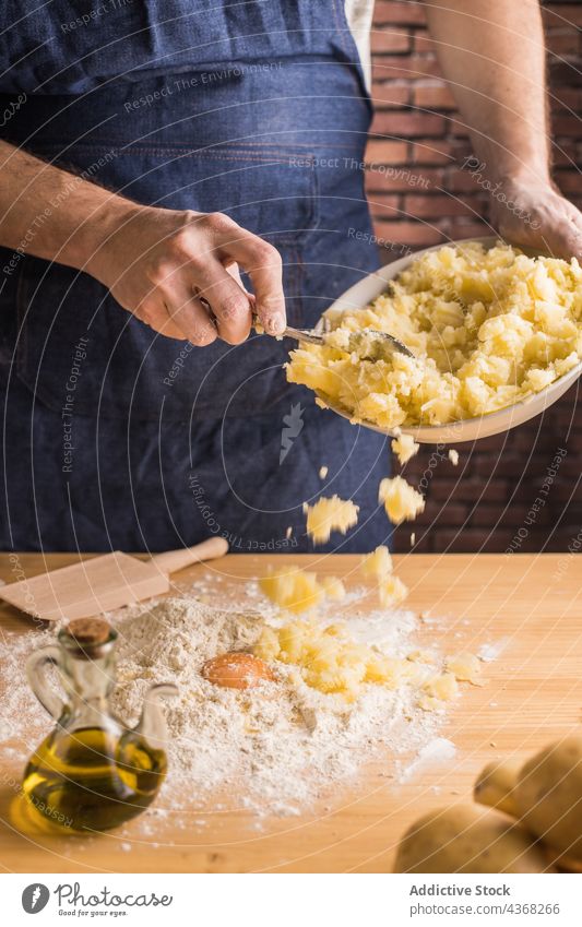Kropfenkoch, der Kartoffeln mit Mehl und Ei vermischt Mann Koch gestampft Teigwaren hinzufügen Küche heimwärts männlich Gnocchi Spätzle Rezept vorbereiten