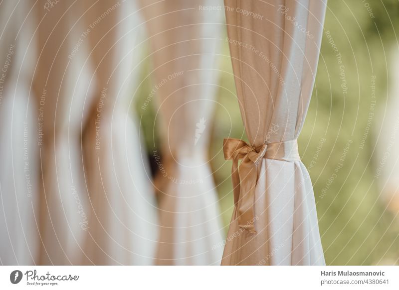 weiße und goldene Vorhänge in der Hochzeitslocation, selektiver Fokus abstrakt Accessoire Bogen Ordnung Hintergrund schön hochzeitlich hell braun Feier Festakt