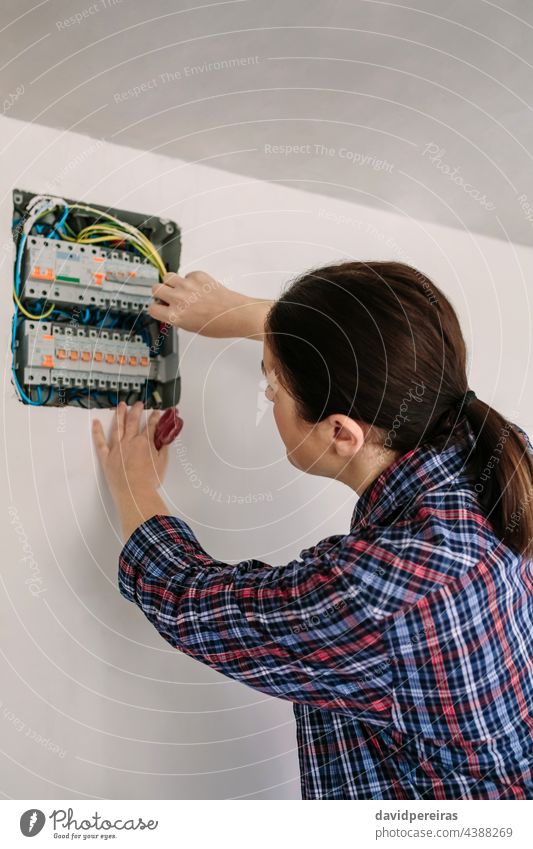 Elektriker, der an der Verteilertafel eines Hauses arbeitet Frau unkenntlich Elektrotechniker Elektromonteur Elektroinstallation Besichtigung Prüfung arbeiten