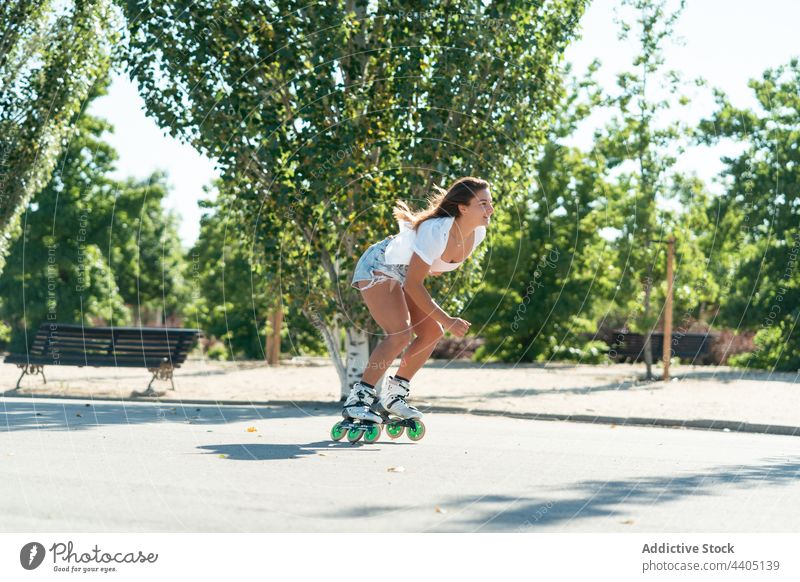 Frau in Rollschuhen und mit Stunt Rollerblade Trick Ausgeglichenheit Skater Sommer Rad Straße Aktivität üben sonnig Sonnenlicht Sommerzeit passen urban
