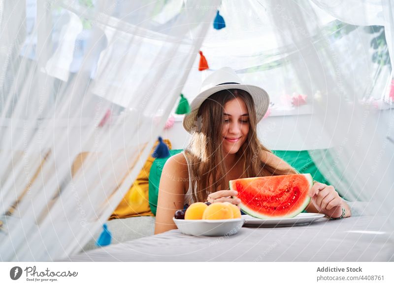 Fröhliche Frau mit frischer Wassermelone süß Sommer reif jung geschmackvoll Hinterhof Zelt Lächeln heiter Glück essen genießen lecker positiv Gesundheit