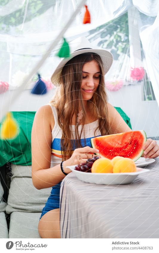 Fröhliche Frau mit frischer Wassermelone süß Sommer reif jung geschmackvoll Hinterhof Zelt Lächeln heiter Glück essen genießen lecker positiv Gesundheit