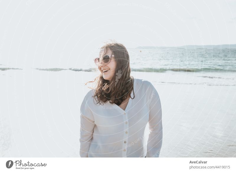 Glückliche junge Frau lachend und lächelnd am Strand an einem Sommertag, genießen Sie den Urlaub, Konzept der Freundschaft genießen die Outdoor Fröhlichkeit