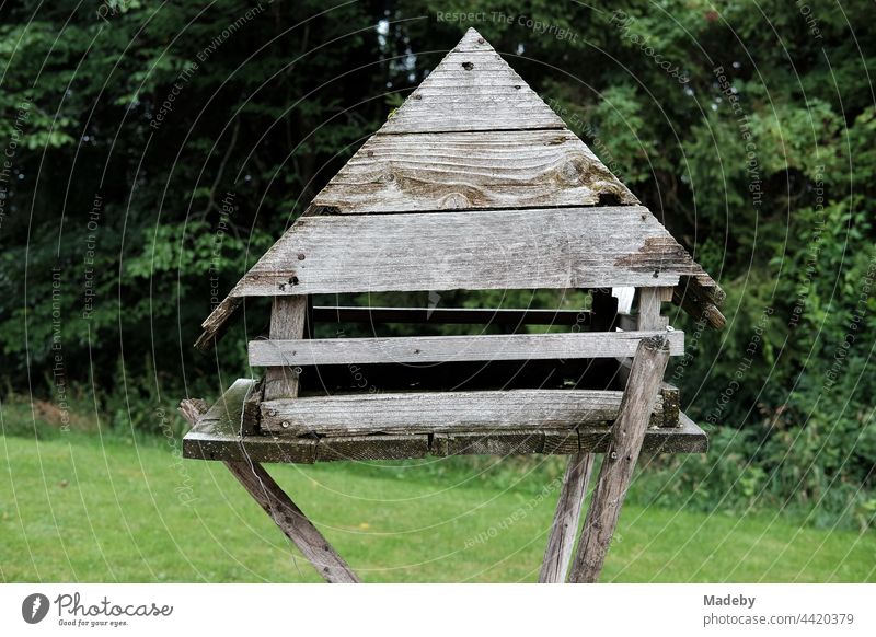 Selbstgebautes großes Vogelhaus aus Holz mit Spitzgiebel in einem grünen Garten am Waldrand auf einem Bauernhof in Rudersau bei Rottenbuch im Kreis Weilheim-Schongau in Oberbayern