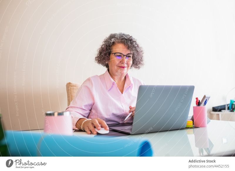 Geschäftsfrau mit Tablet und Laptop bei der Arbeit im Büro Tablette Internet online Lächeln selbständig Arbeitsplatz benutzend Apparatur Frau Gerät Kaffee Job