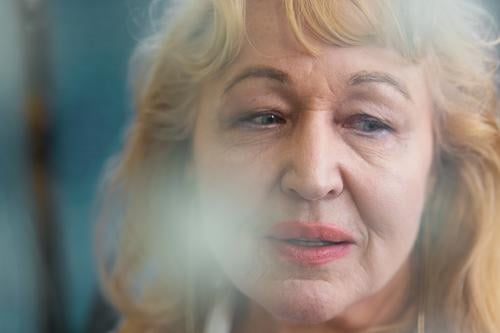 Porträt einer älteren Frau mit leerem Blick Senior in den Ruhestand getreten Gesicht unbesetzt blanko Falte gealtert blond helles Haar Lebensalter neben