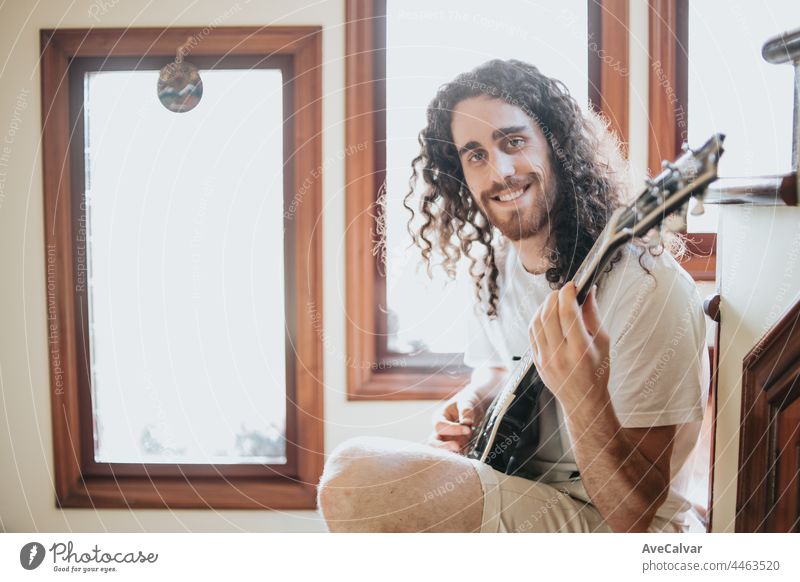 Attraktiver Mann mit langen Haaren spielt Akustikgitarre im Freien, Hippie, entspannen, Park Lebensstil, Hobby, Kopie Raum Musik eine Person Typ lange Haare