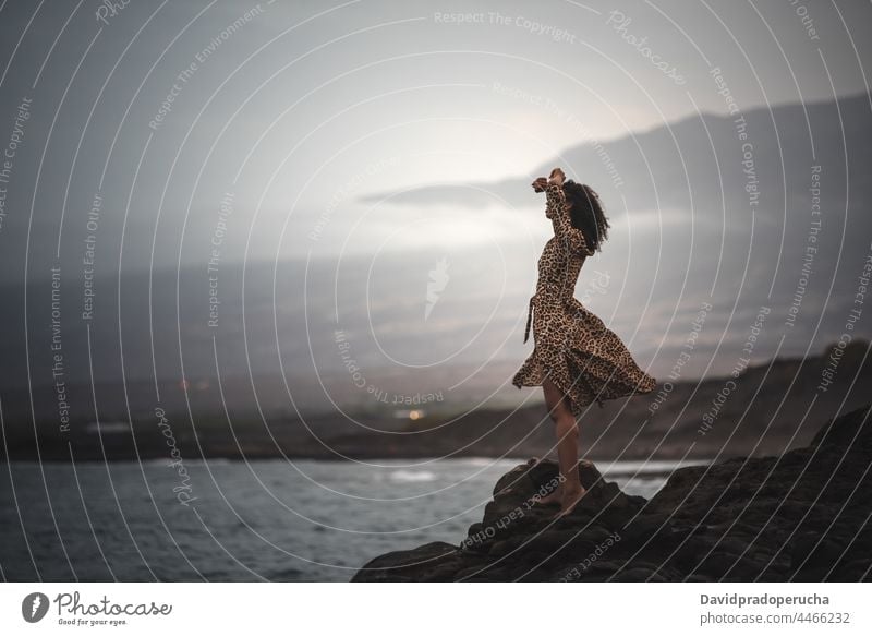 Frau stehend auf einer Klippe am Meeresufer Seeküste horizontal schwarz Ethnizität Textfreiraum im Freien Feiertag ethnisch Körper Lifestyle exotisch Wasser