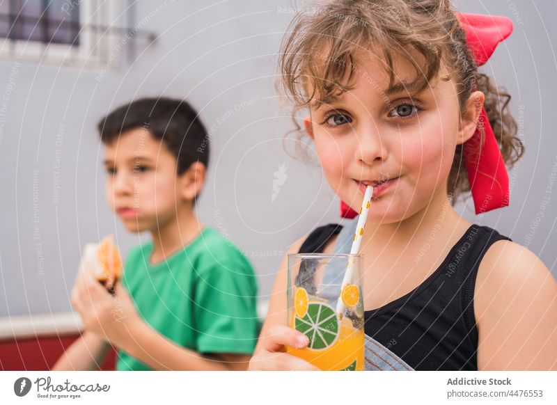 Glückliche Kinder essen Sandwiches und trinken Saft Belegtes Brot Lebensmittel Kindheit Snack Geschmack Spaß haben Getränk Kannen Lachen Lächeln sorgenfrei