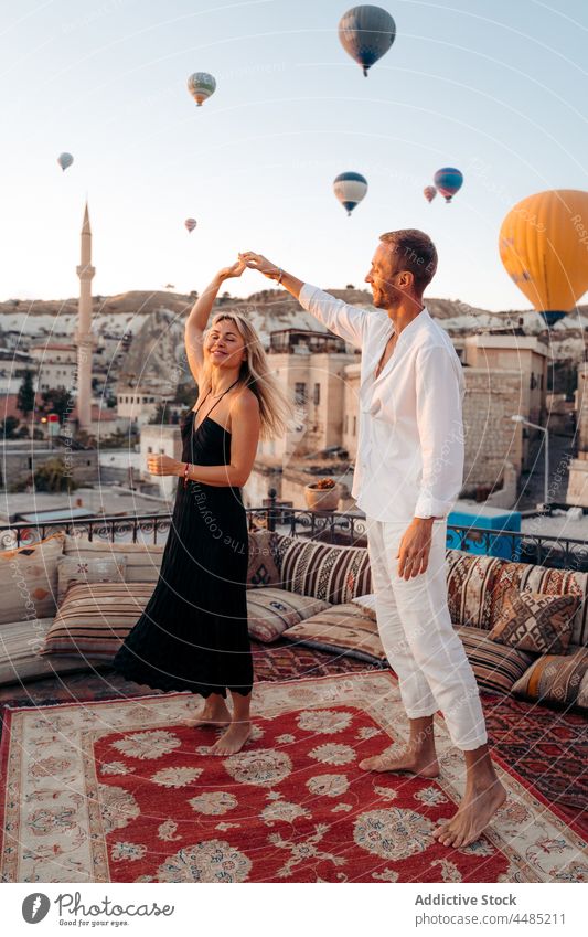 Paar tanzt gegen fliegende Heißluftballons Tanzen Seelenverwandter Ballone Dachterrasse Termin & Datum romantisch Zusammensein Liebe Partnerschaft Bonden