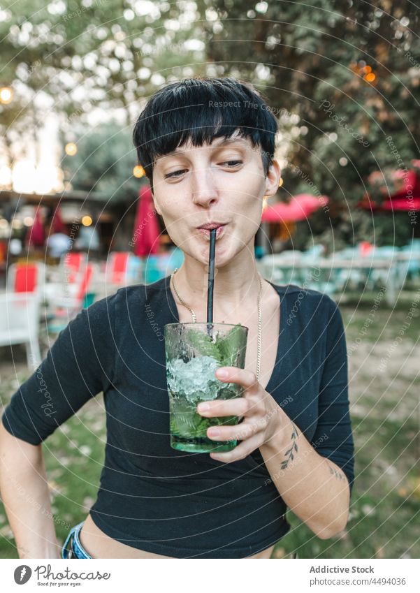 Frau trinkt Cocktail mit Minze im Garten trinken Sommer Park Erfrischung Getränk genießen Glas cool geschmackvoll heiter lecker Würfel Glück Eis Alkohol kalt
