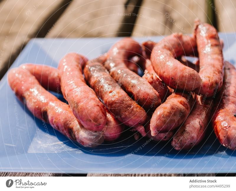 Haufen von gebratenen Würsten auf dem Tisch Wurstwaren Fleisch Lebensmittel gegrillt Landschaft Mahlzeit grillen dienen Kalorie geschmackvoll lecker Sommer