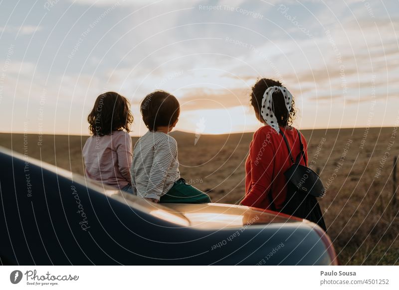 Rückansicht Mutter mit Kindern mit Blick auf den Sonnenuntergang Zusammensein Zusammengehörigkeitsgefühl Familie & Verwandtschaft Herbst authentisch